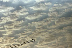 Labourers work on the edge of a ladder during the construction of a building in Mumbai Labourers work on the edge of a ladder during the construction of a building in Mumbai