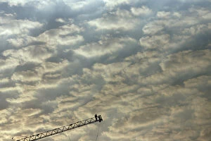 Images Dated 20th March 2007: Labourers work on the edge of a ladder during the construction of a building in Mumbai