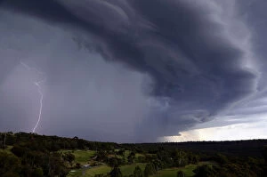 Images Dated 5th December 2014: Lightning can be seen as a large storm front crosses over the Sydney suburb of Wakehurst