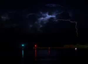 A lightning storm is seen beyond the entrance to Vallettas Grand Harbour A lightning storm is seen beyond the entrance to Vallettas Grand Harbour
