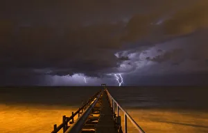 Lightning strikes over a pier during a storm in Atlit Lightning strikes over a pier during a storm in Atlit