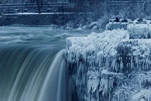 A lone visitor takes a picture near the brink of the ice covered Horseshoe Falls in A lone visitor takes a picture near the brink of the ice covered Horseshoe Falls in
