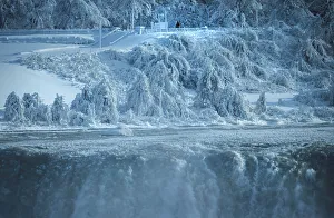 A lone visitor on the United States side of the Niagara River watches as ice chunks A lone visitor on the United States side of the Niagara River watches as ice chunks