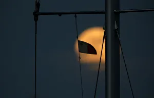 A Maltese flag flies from a yachts mast as a supermoon full moon rises in Pieta A Maltese flag flies from a yachts mast as a supermoon full moon rises in Pieta
