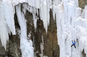 A man climbs up an artificially made wall of ice near the Swiss mountain resort of A man climbs up an artificially made wall of ice near the Swiss mountain resort of
