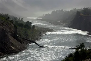 A man crosses over the Neelum River on a collapsed bridge at the Neelum Valley outside A man crosses over the Neelum River on a collapsed bridge at the Neelum Valley outside