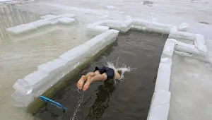 A man dives into the icy waters of a lake during Orthodox Epiphany celebrations in Minsk A man dives into the icy waters of a lake during Orthodox Epiphany celebrations in Minsk