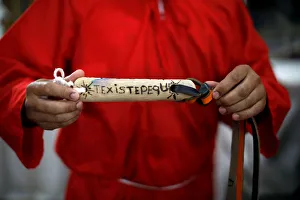 A man dressed as a demon shows the handle of his whip prior to the ceremony known as Los A man dressed as a demon shows the handle of his whip prior to the ceremony known as Los