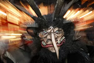 A man dressed as Krampus creature takes part in a parade at Munichs Christmas market