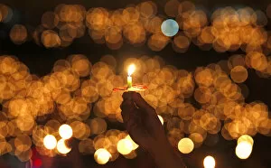 Indonesia Gallery: A man hold a candle during a Christmas mass at the Gelora Bung Karno stadium in Jakarta