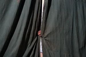 A man holds the curtains before the start of an act at the Jan Baz circus A man holds the curtains before the start of an act at the Jan Baz circus