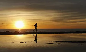 Images Dated 30th May 2013: A man jogs during a sunset along the coast in Valparaiso city