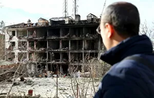 A man looks at a destroyed police station in Cinar in the southeastern city of Diyarbakir