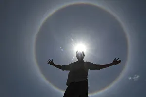 A man poses for photos as solar halo is seen in the sky of Brasilia A man poses for photos as solar halo is seen in the sky of Brasilia