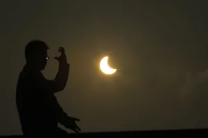 A man practices taichi during an eclipse at the Bund along the Huangpu River in Shanghai A man practices taichi during an eclipse at the Bund along the Huangpu River in Shanghai
