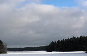 Man is seen fishing on a frozen lake at the Pajulahti sports center near Lahti Man is seen fishing on a frozen lake at the Pajulahti sports center near Lahti