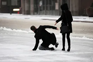 A man slips on ice covered sidewalk as freezing rain falls in Toronto A man slips on ice covered sidewalk as freezing rain falls in Toronto