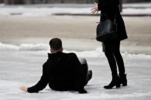 A man slips on icy snow covered sidewalk as freezing rain falls in Toronto A man slips on icy snow covered sidewalk as freezing rain falls in Toronto