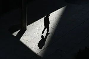 A man walks on a footbridge in Tokyos Shiodome business district in Tokyo A man walks on a footbridge in Tokyos Shiodome business district in Tokyo