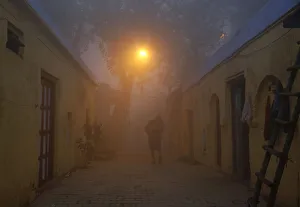 A man walks out of his house in an alley on a cold and foggy morning in New Delhi A man walks out of his house in an alley on a cold and foggy morning in New Delhi