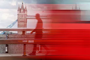 A man walks across London Bridge behind a barrier to prevent traffic mounting the A man walks across London Bridge behind a barrier to prevent traffic mounting the