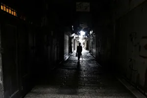 A man walks past closed shops as Palestinian political parties call for a general strike A man walks past closed shops as Palestinian political parties call for a general strike