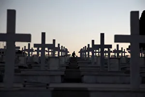 A man walks past the graves of soldiers killed in the 1974 Turkish invasion of Cyprus at A man walks past the graves of soldiers killed in the 1974 Turkish invasion of Cyprus at