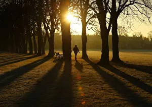 A man walks through Victoria Park at sunrise in Leicester A man walks through Victoria Park at sunrise in Leicester