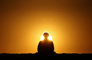 A man watches the sun set on Venice Beach in Los Angeles A man watches the sun set on Venice Beach in Los Angeles
