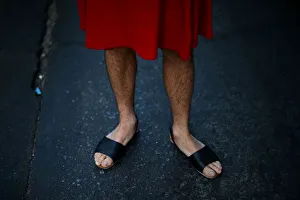 A man wears a dress as he attends a march to mark International Womens Day in Santiago A man wears a dress as he attends a march to mark International Womens Day in Santiago