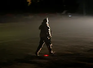 A member of the Afghan security forces arrives the site of an attack on the A member of the Afghan security forces arrives the site of an attack on the