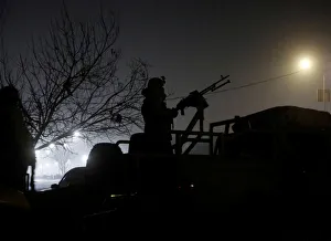 A member of the Afghan security forces keeps watch near the site of an attack on the A member of the Afghan security forces keeps watch near the site of an attack on the