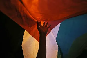 A member of the Palestinian community in Chile holds up a Palestinian flag during a A member of the Palestinian community in Chile holds up a Palestinian flag during a