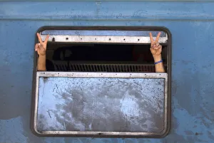 Migrants gesture after boarding a train after crossing the Macedonian-Greek border near Migrants gesture after boarding a train after crossing the Macedonian-Greek border near