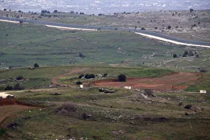 Military vehicles can be seen positioned on the Israeli side of the border with Syria Military vehicles can be seen positioned on the Israeli side of the border with Syria