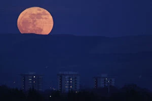 Images Dated 19th March 2011: The moon rises over the horizon above the Peak District national park near Manchester