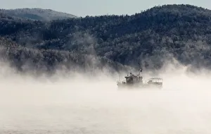 A motorboat travels along the Yenisei River in the Siberian Taiga area as the air A motorboat travels along the Yenisei River in the Siberian Taiga area as the air