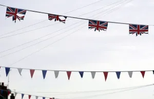 Prints of Union flags and coloured bunting hang above a street in South Belfast January 8, 2013 Politic Prints: Print of Union flags and bunting above a South Belfast street