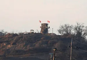A North Korean flag flutters on the top of their guard post inside North Korean territory A North Korean flag flutters on the top of their guard post inside North Korean territory