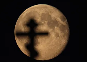 An Orthodox cross is silhouetted against the full moon near the village of Chist, Belarus An Orthodox cross is silhouetted against the full moon near the village of Chist, Belarus