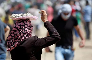 Palestinian woman carries a tray with stones on her head during a protest marking al-Quds Palestinian woman carries a tray with stones on her head during a protest marking al-Quds
