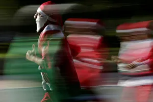 Participants dressed as Santa Claus take part in the annual race known as Run Santa Run Participants dressed as Santa Claus take part in the annual race known as Run Santa Run