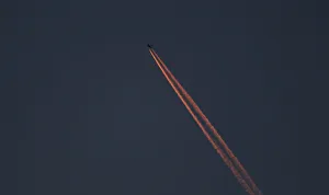 A passenger plane leaves behind contrails as it flies in the skies over London Luton A passenger plane leaves behind contrails as it flies in the skies over London Luton