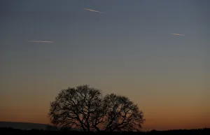 Passenger planes leave behind contrails as they fly in the skies over London Luton Airport Passenger planes leave behind contrails as they fly in the skies over London Luton Airport