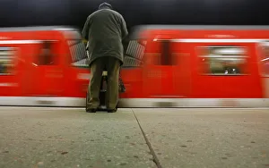 Passenger waits on a platform as a suburban train leaves the platform during a strike Passenger waits on a platform as a suburban train leaves the platform during a strike