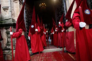 Penitents leave a church as they take part in a procession during the Holy Week in Ronda Penitents leave a church as they take part in a procession during the Holy Week in Ronda