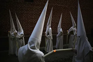 Penitents light their candles as they take part in the Humildad brotherhood Palm Sunday Penitents light their candles as they take part in the Humildad brotherhood Palm Sunday