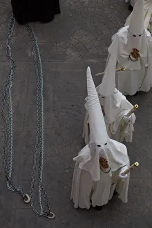 Penitents wait for the start of the procession of the Sant Crist de la Sang brotherhood Penitents wait for the start of the procession of the Sant Crist de la Sang brotherhood