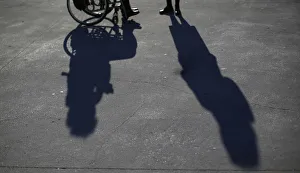 People attend a protest by disabled persons against government austerity measures People attend a protest by disabled persons against government austerity measures