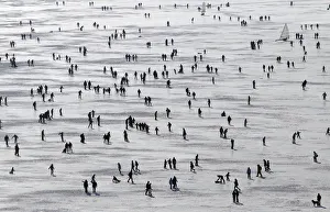 People enjoy a sunny winter afternoon on the frozen Lac de Joux in Le Pont People enjoy a sunny winter afternoon on the frozen Lac de Joux in Le Pont